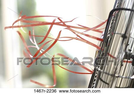 Close-up of an electric fan blowing attached streamers View Large Photo Image Stock Photograph - Close-up of an electric fan blowing attached streamers. Fotosearch