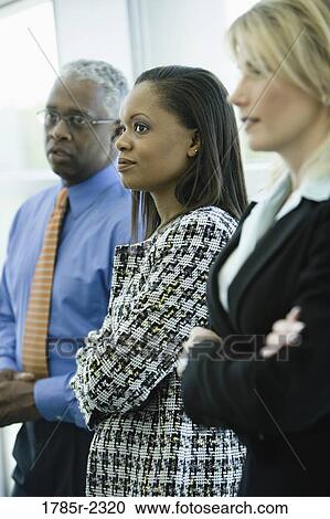 Stock Image - Close-up of business colleagues standing together. Fotosearch