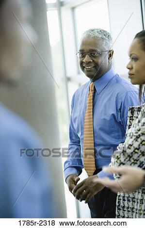 Close-up of business colleagues standing together View Large Photo Image Stock Photo - Close-up of business colleagues standing together. Fotosearch