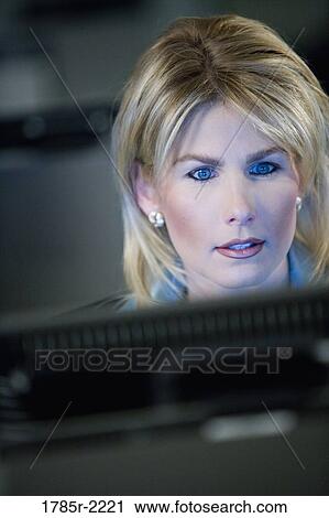 Close-up of business woman in front of computer monitor View Large Photo Image Stock Image - Close-up of business woman in front of computer monitor. Fotosearch