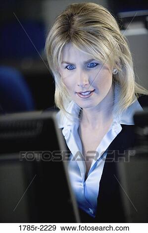 Stock Photo - Close-up of business woman in front of computer monitor. Fotosearch