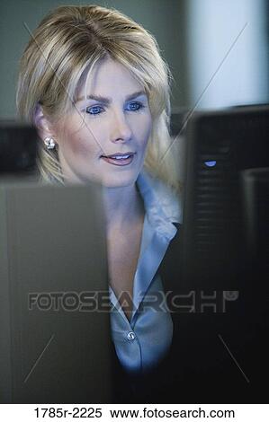 Close-up of business woman in front of computer monitor View Large Photo Image Stock Photography - Close-up of business woman in front of computer monitor. Fotosearch