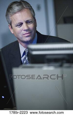 Close-up of businessman in front of computer monitor View Large Photo Image Stock Image - Close-up of businessman in front of computer monitor. Fotosearch