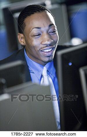 Close-up of businessman in front of computer monitor View Large Photo Image Stock Photo - Close-up of businessman in front of computer monitor. Fotosearch