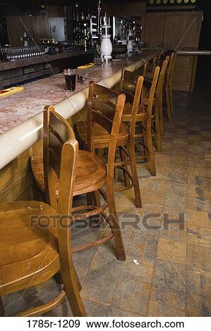Close-up of empty bar stools at bar View Large Photo Image Stock Photo - Close-up of empty bar stools at bar. Fotosearch