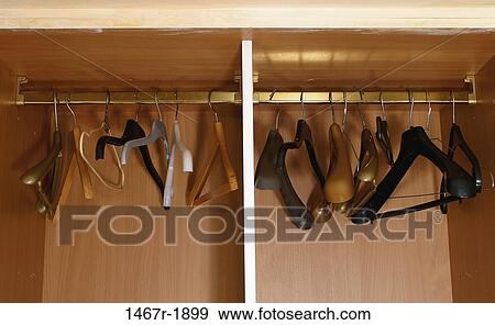 Close-up of empty hangers in a closet View Large Photo Image Stock Photo - Close-up of empty hangers in a closet. Fotosearch