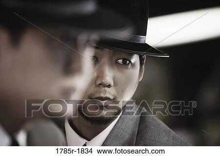 Close-up of two young Asian men wearing suits and hats View Large Photo Image Picture - Close-up of two young Asian men wearing suits and hats. Fotosearch