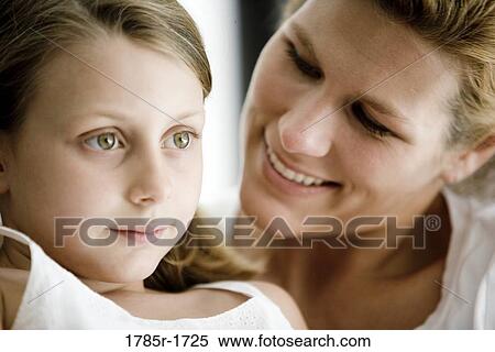 Stock Photography - Close-up of woman looking affectionately at her daughter. Fotosearch