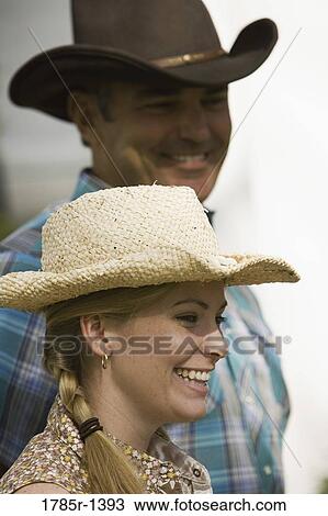 Close-up view of a young woman with her father wearing cowboy hats View Large Photo Image Stock Image - Close-up view of a young woman with her father wearing cowboy hats. Fotosearch