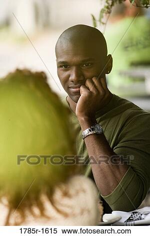 Stock Photography - Close-up view of young man gazing at his woman companion. Fotosearch