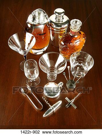 Stock Image - Collection of various drinking supplies, tools and glassware on wooden table. Fotosearch