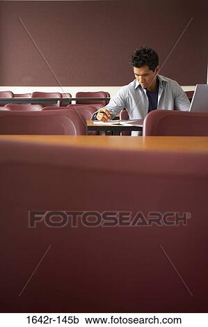 College student sitting in a lecture hall and studying View Large Photo Image Stock Image - College student sitting in a lecture hall and studying. Fotosearch