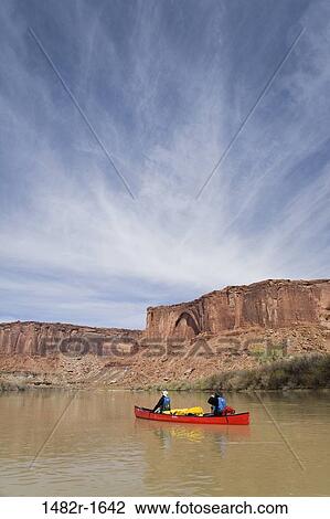 Stock Image - Couple canoeing in a river, Green River, Canyonlands National Park, Utah, USA. Fotosearch