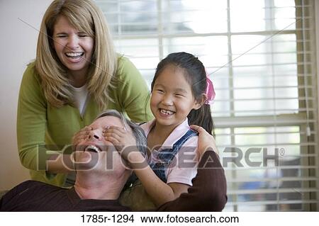 Daughter covering father's eyes View Large Photo Image Picture - Daughter covering father's eyes. Fotosearch