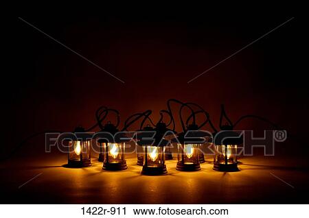 Electric lanterns glowing warm light in darkness View Large Photo Image Stock Image - Electric lanterns glowing warm light in darkness. Fotosearch