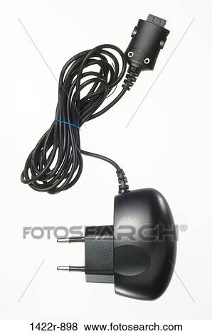 Stock Photo - Electrical charging power unit with wrapped cord and plug. Fotosearch