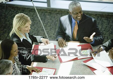 Elevated view of business colleagues in a meeting View Large Photo Image Stock Photo - Elevated view of business colleagues in a meeting. Fotosearch