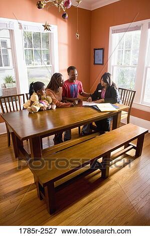 Family at home signing papers with agent View Large Photo Image Stock Photo - Family at home signing papers with agent. Fotosearch