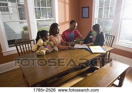 Family at home signing papers with agent View Large Photo Image Stock Photograph - Family at home signing papers with agent. Fotosearch