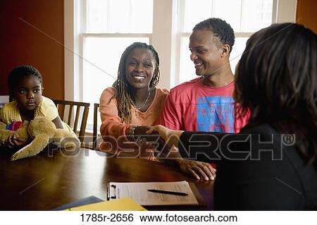 Family at home signing papers with agent View Large Photo Image Stock Photograph - Family at home signing papers with agent. Fotosearch