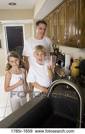 Family making breakfast View Large Photo Image Stock Photo - Family making breakfast. Fotosearch