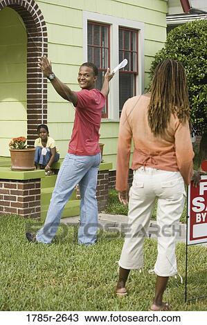 Family outside house with For Sale sign View Large Photo Image Stock Image - Family outside house with For Sale sign. Fotosearch