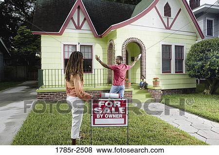 Family outside house with woman standing by "For Sale" sign View Large Photo Image Stock Photo - Family outside house with woman standing by "For Sale" sign. Fotosearch
