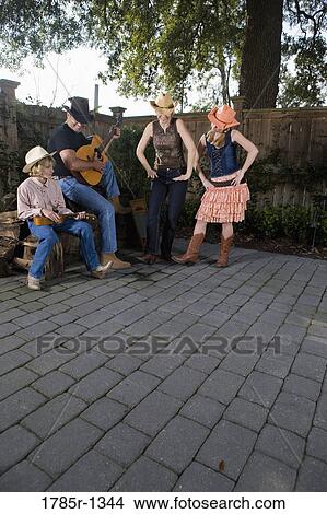 Picture - Family playing country music and dancing together. Fotosearch