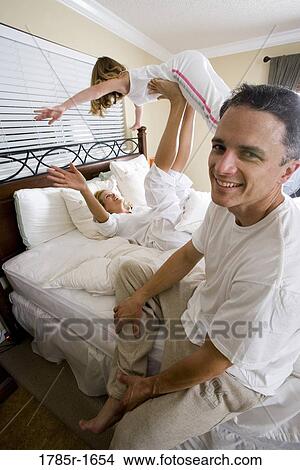 Family playing in bedroom View Large Photo Image Picture - Family playing in bedroom. Fotosearch