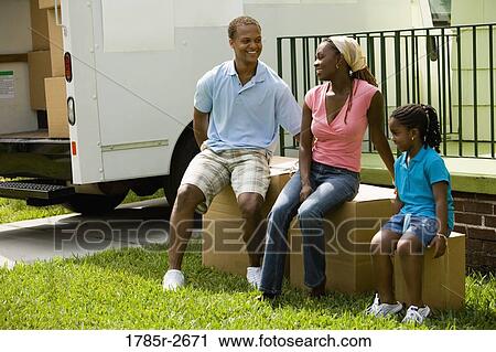 Family sitting on boxes outside house View Large Photo Image Stock Image - Family sitting on boxes outside house. Fotosearch