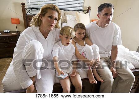 Family sitting on foot of bed in pajamas View Large Photo Image Stock Photography - Family sitting on foot of bed in pajamas. Fotosearch