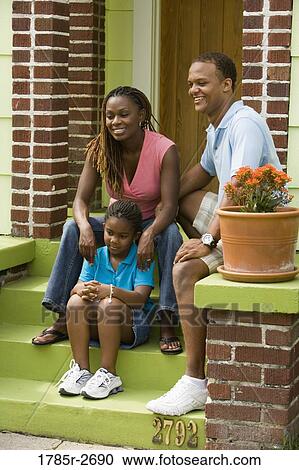 Family sitting on front steps of house View Large Photo Image Stock Image - Family sitting on front steps of house. Fotosearch