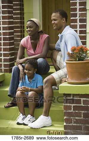 Family sitting on front steps of house View Large Photo Image Stock Photo - Family sitting on front steps of house. Fotosearch