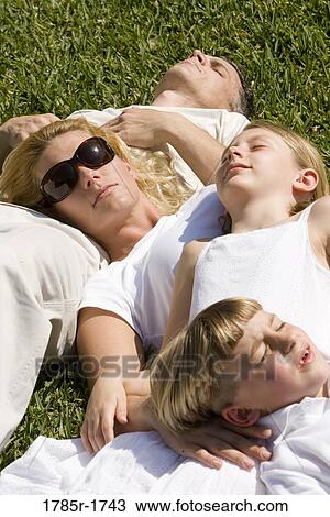 Family sleeping on grass View Large Photo Image Stock Image - Family sleeping on grass. Fotosearch