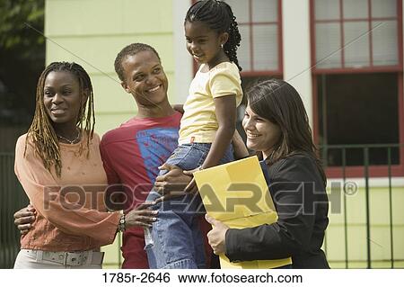 Family standing outside a house with a real estate broker View Large Photo Image Stock Photograph - Family standing outside a house with a real estate broker. Fotosearch