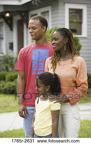 Family standing outside house View Large Photo Image Stock Image - Family standing outside house. Fotosearch