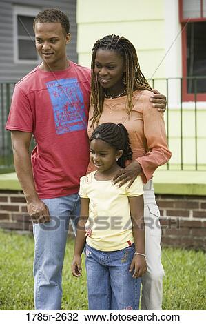 Family standing outside house View Large Photo Image Stock Image - Family standing outside house. Fotosearch