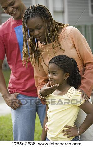 Family standing outside house View Large Photo Image Stock Photograph - Family standing outside house. Fotosearch