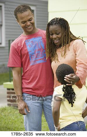 Family standing outside house View Large Photo Image Stock Photography - Family standing outside house. Fotosearch
