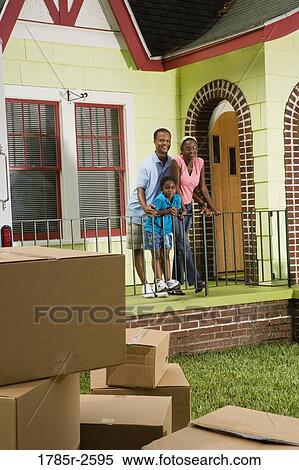 Family standing outside house, with moving boxes piled in driveway View Large Photo Image Stock Photography - Family standing outside house, with moving boxes piled in driveway. Fotosearch