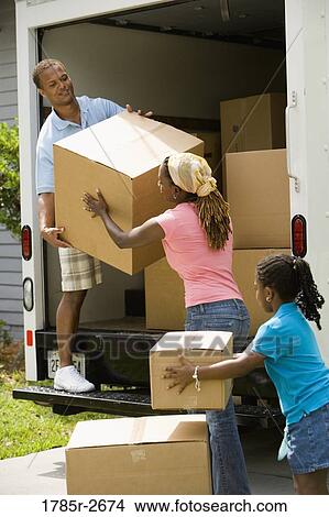 Family unloading boxes from a moving truck View Large Photo Image Picture - Family unloading boxes from a moving truck. Fotosearch