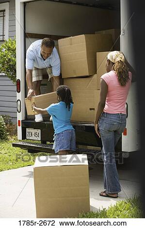 Family unloading boxes from a moving truck View Large Photo Image Stock Image - Family unloading boxes from a moving truck. Fotosearch