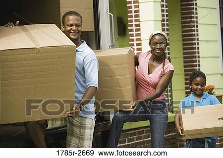 Family unloading boxes from a moving truck View Large Photo Image Stock Photo - Family unloading boxes from a moving truck. Fotosearch
