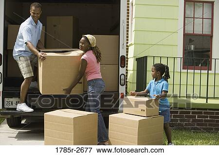 Family unloading boxes from a moving truck View Large Photo Image Stock Photo - Family unloading boxes from a moving truck. Fotosearch
