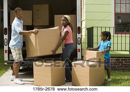 Stock Photo - Family unloading boxes from a moving truck. Fotosearch