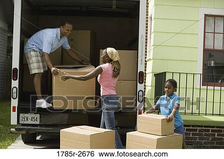 Family unloading boxes from a moving truck View Large Photo Image Stock Photograph - Family unloading boxes from a moving truck. Fotosearch