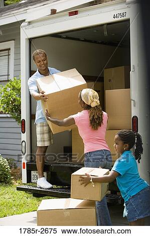 Family unloading boxes from a moving truck View Large Photo Image Stock Photography - Family unloading boxes from a moving truck. Fotosearch