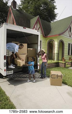 Family unloading boxes from moving truck View Large Photo Image Stock Image - Family unloading boxes from moving truck. Fotosearch