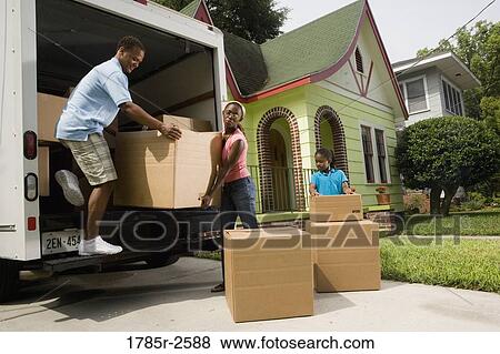 Family unloading boxes from moving truck View Large Photo Image Stock Photo - Family unloading boxes from moving truck. Fotosearch