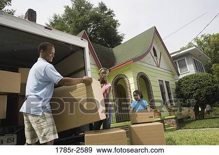 Family unloading boxes from moving truck View Large Photo Image Stock Photo - Family unloading boxes from moving truck. Fotosearch